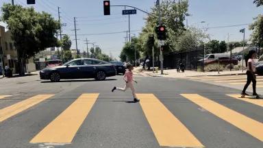 Children crossing a street safely on a crosswalk