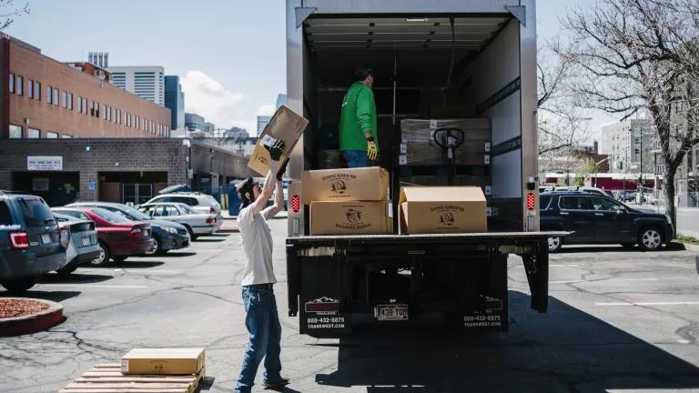 Matt Karm (in truck) and Andrew Sanford unloading boxes of fresh food being delivered by We Don’t Waste, one of the largest food recovery organizations in Colorado, at Samaritan House in Denver, Colorado, on May 2, 2019.