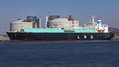A large tanker ship with the letters "LNG" painted on the side