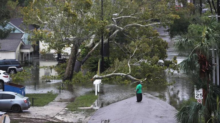 A person looks out at a flooded neighborhood as Hurricane Sally brings heavy rain, high winds, and a dangerous storm surge through the area on September 16, 2020 in Pensacola, Florida.