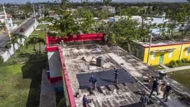 An aerial view of MIT volunteers installing solar panels on a rooftop in Loiza, Puerto Rico