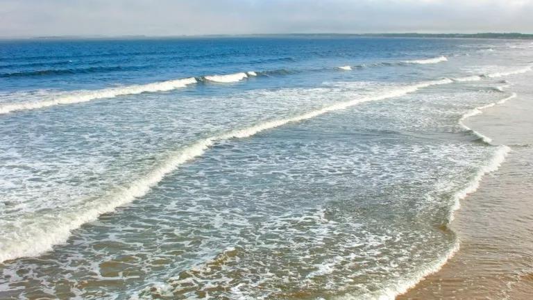 Waves breaking on the shore of Old Orchard Beach, Maine.